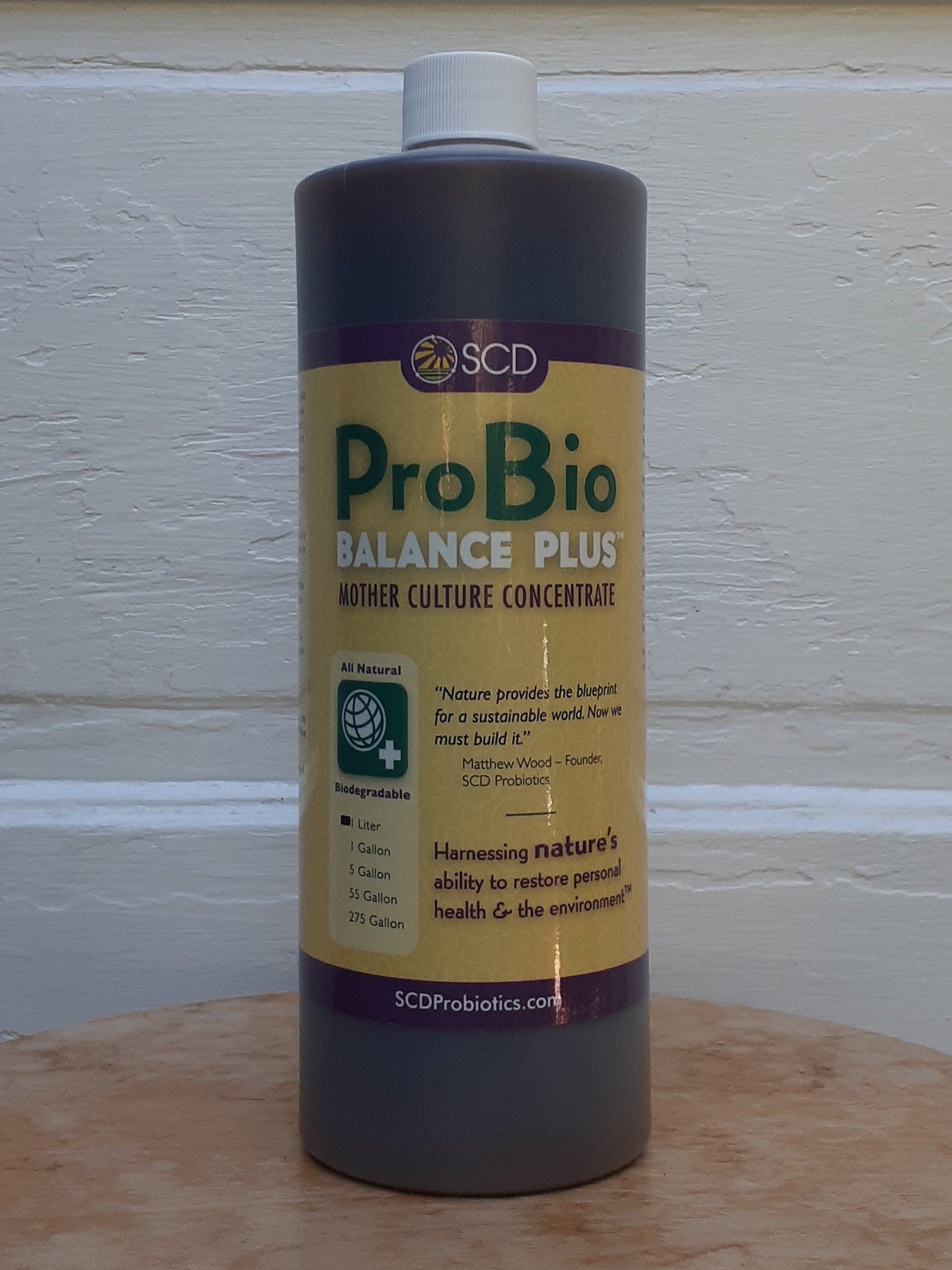 ProBio Balance Plus bottle on a wooden surface with a light-colored wall background